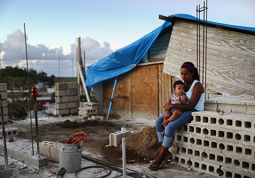 Mother Isamar holds her baby Saniel, 9 months, at their makeshift home. Photo: Mario Tama / Getty Images